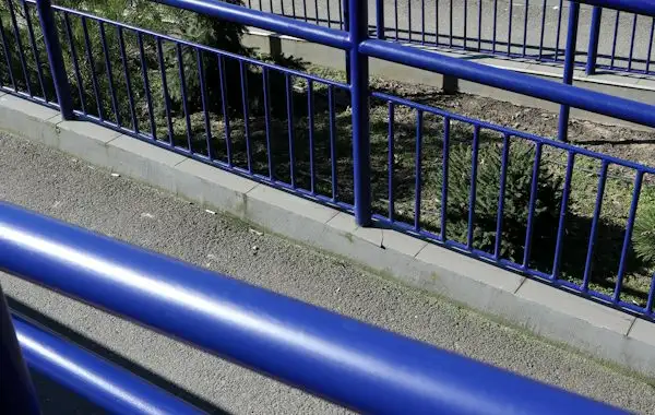 Ramp with sturdy blue handrails along a walkway